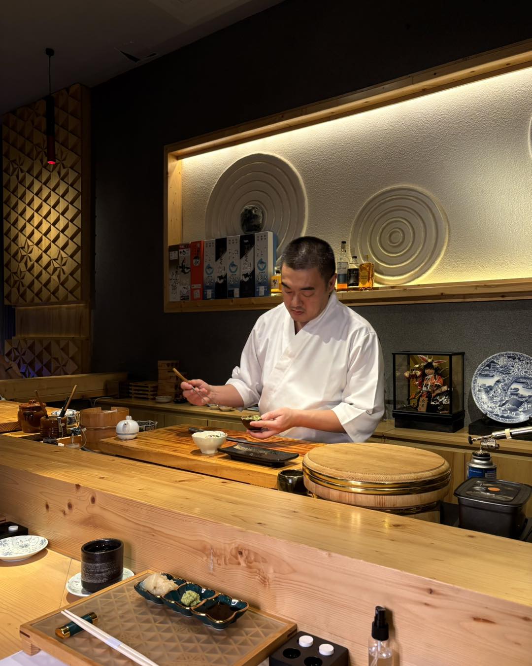 The chef carefully prepares a course behind Nishiyama's timber counter